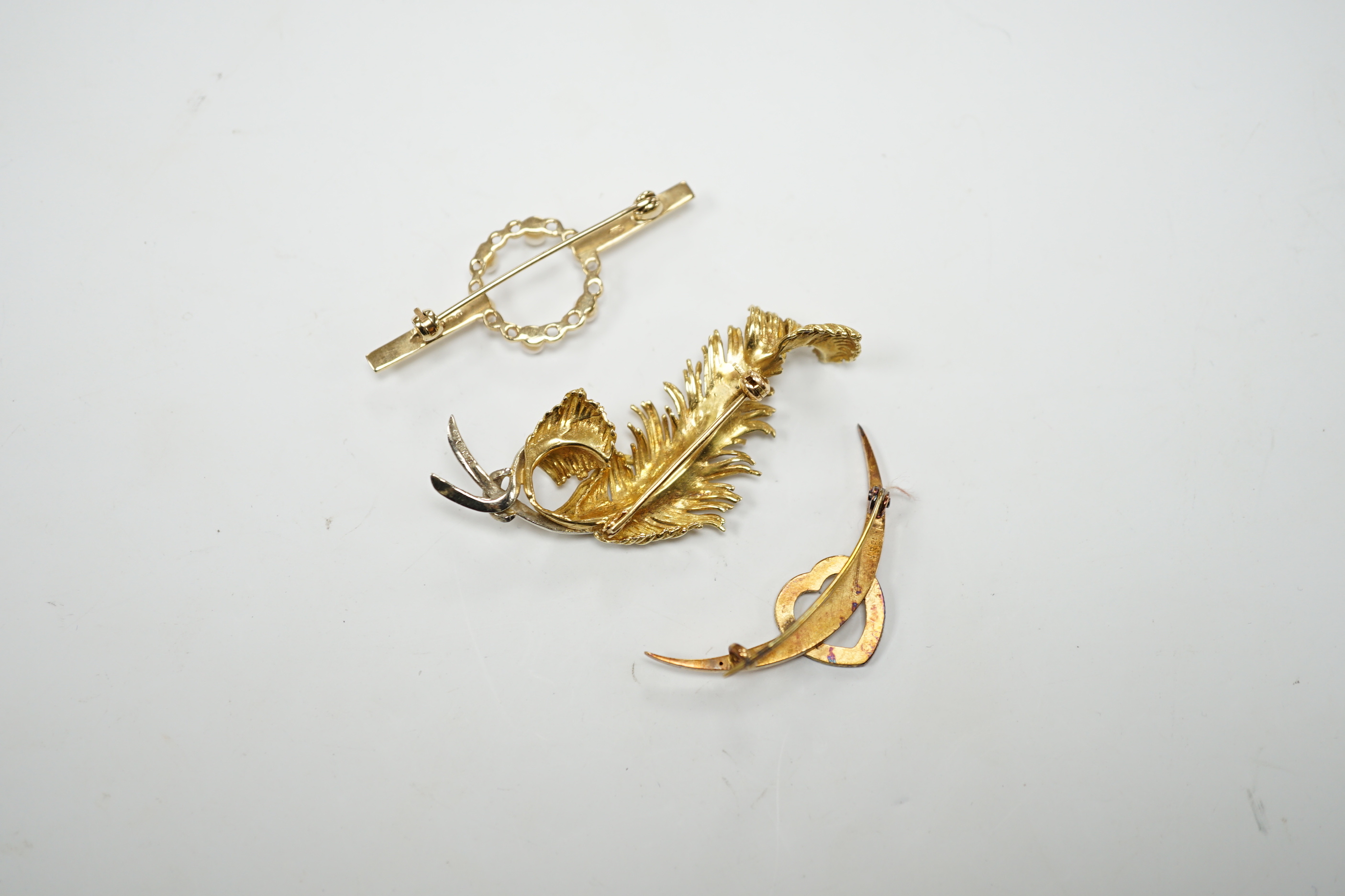 A 1960's 18ct gold and diamond chip set scrolling fern brooch by Cropp & Farr, 52mm, an 18ct heart and crescent brooch, gross weight 11.9 grams and a 9ct and seed pearl bar brooch, gross weight 2.8 grams.